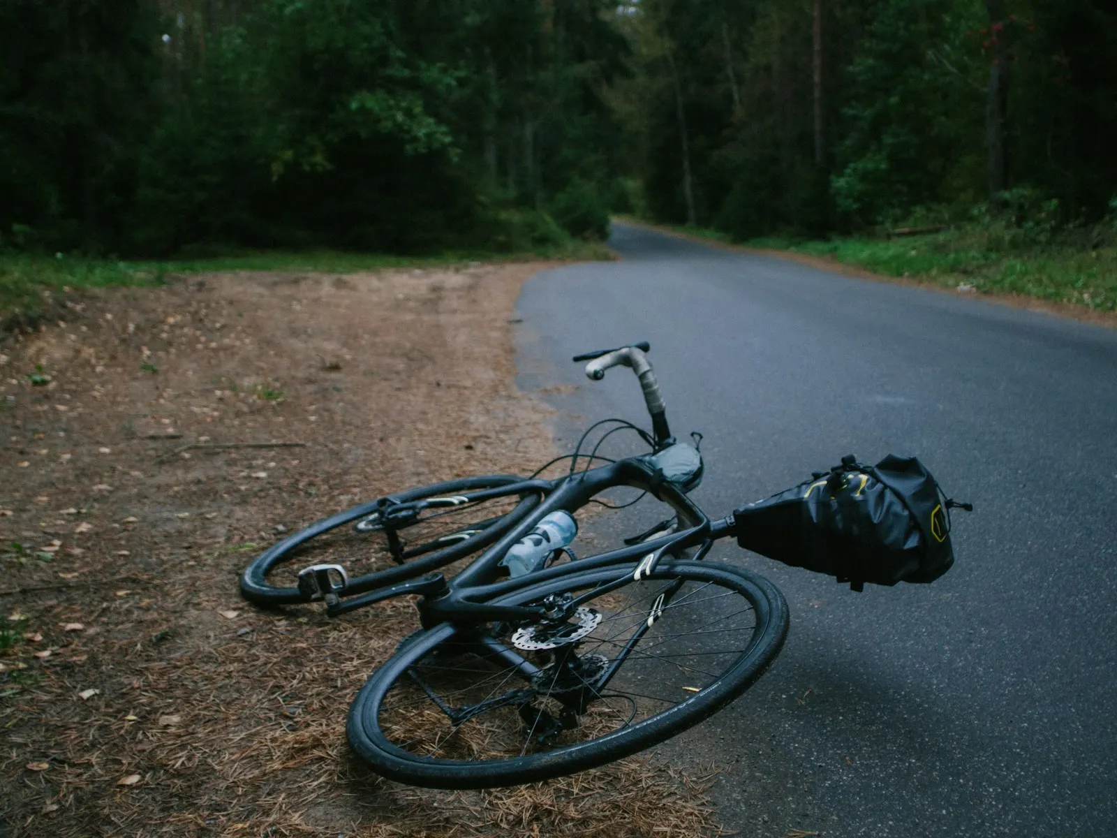 Rennrad liegt nach einem Sturz auf einer Landstraße – Fahrradunfall mit Schaden an Rahmen und Laufrädern
